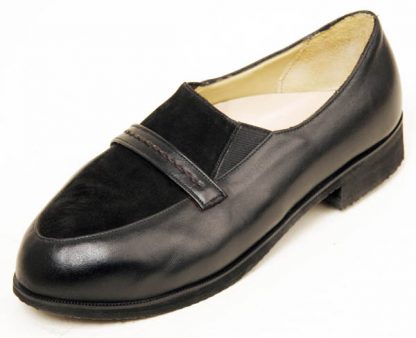 Elastic sided shoe with laid under apron and band