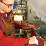 George, a bespoke shoemaker at Bill Bird Shoes, trims a heavy leather sole