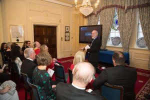 Bill Bird introduces the films to an invited audience of British and international footwear specialists at a gala dinner in London.